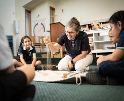 Female Chaplain playng with children